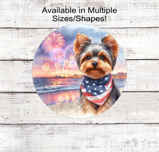 A beautiful Yorkshire Terrier dog wearing an American Flag Bandanna on a Beach with Fireworks.