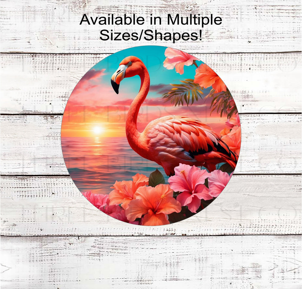 A beautiful pink Flamingo surrounded by Hibiscus flowers at sunset at the Beach.